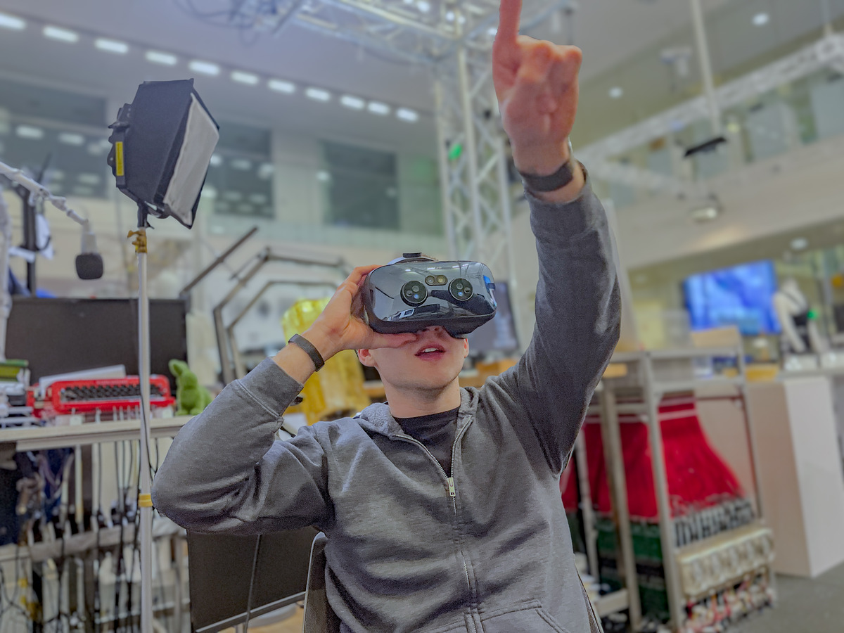 Testing Prakash AR with a mixed reality headset while reaching upward in the lab